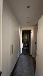 an empty hallway with a hallway leading to a bathroom at dockrail and cast anchor drive Apartment in Cape Town