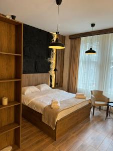 1 dormitorio con 1 cama grande y 2 luces colgantes en Talia Apartments, en Belgrado
