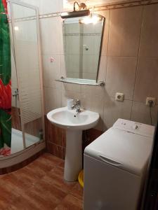 a bathroom with a sink and a mirror and a refrigerator at Kriopigi Apartments 2 in Kriopigi +22 photos