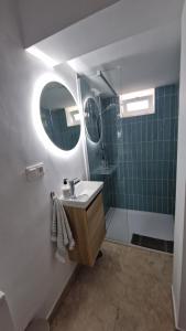 a bathroom with a sink and a mirror at Los Cipreses - Casa Adán in Almuñécar