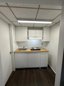 an empty kitchen with white cabinets and a sink at Hospitality House Union City US 51, TN in Union City