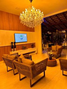- un salon avec une table, des chaises et un lustre dans l'établissement ECO PORTO RESORT, à Mirabela