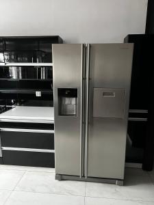a stainless steel refrigerator in a kitchen at Studio na Miarę in Jarocin