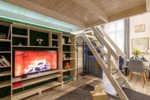 a living room with a fireplace and a staircase at Bárka Home in downtown Buda in Budapest