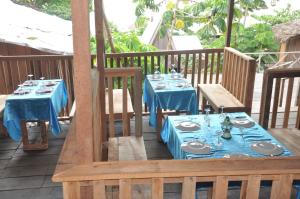 a table with blue table cloths on a deck at Kribi-Lodge in Kribi