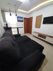 a living room with a couch and a table at Apartamento com Vista Única e Maravilhosa !!! in São Vicente