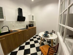 a small kitchen with a table and a sink at Tabago Studio 16 in Nysa