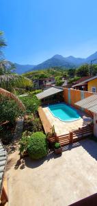a view of a swimming pool in a house at Suítes no paraíso da Ilhabela in Ilhabela