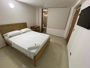 Postel nebo postele na pokoji v ubytování ApartaHotel Los Naranjos