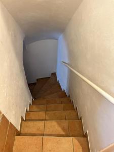 a staircase in a room with white walls and a tile floor at ZMRZLINOVÝ DOMEČEK (Ice cream housei) in Mikulov