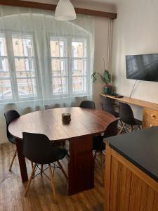 a dining room with a large wooden table and chairs at ZMRZLINOVÝ DOMEČEK (Ice cream housei) in Mikulov