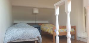 a bedroom with a bed and a table with a lamp at la maisonnette à 1200 m de la mer in Agon Coutainville