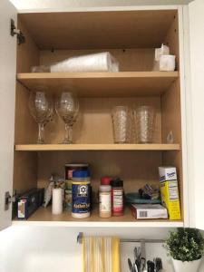 a cabinet with wine glasses and other items in it at Cozy and sweet home in Miami