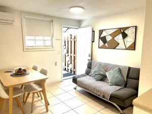 a living room with a couch and a table at Cozy and sweet home in Miami