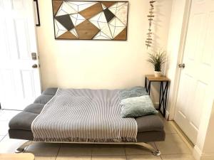 a bed sitting in the corner of a room at Cozy and sweet home in Miami