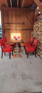 a room with a table and chairs and a stone wall at Ferienwohnung Haske mit Wallbox in Gifhorn