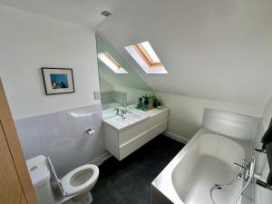 a bathroom with a toilet and a sink and a tub at Lovely house & garden, short walk to town & beach. in Fife