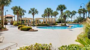 a resort with a pool and palm trees at Westwinds 4826 in Destin