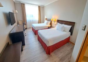 Postel nebo postele na pokoji v ubytování Hotel Diego de Almagro Lomas Verdes