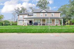 a house on a street with a driveway at Victory Views Estate: Luxury Guest Loft in South Bend