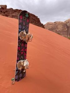 a skateboard sitting on top of a sand dune at Tamim Luxury Camp in Wadi Rum
