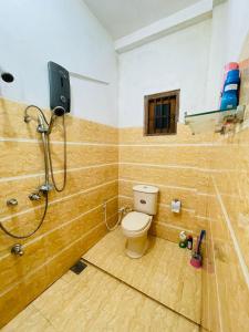 a bathroom with a shower and a toilet in it at Shiv's Villa in Galle