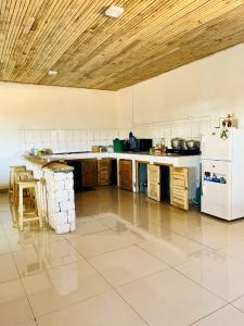 a large kitchen with a counter and a refrigerator at TENDRY in Toliara
