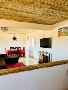 a living room with a couch and a flat screen tv at TENDRY in Toliara