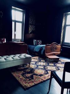 a living room with a couch and a rug at L'ancien Mystic ManOir DeDame in Ventron