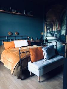 a bedroom with a bed and a couch at L'ancien Mystic ManOir DeDame in Ventron