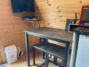 a desk in a room with a laptop on it at kilcamb camping Pods in Edinbane