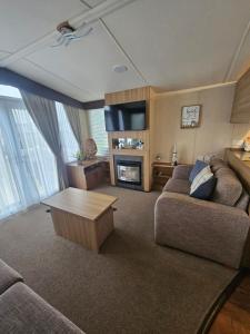a living room with a couch and a coffee table at Oak Green in Gristhorpe