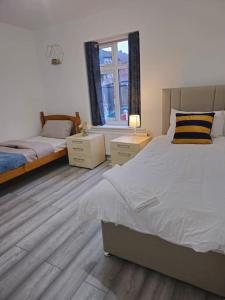 a bedroom with two beds and a window at SwankyHome4Groups/Contractors/M5 in Dudley