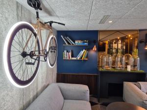 a bike hanging on a wall in a room at Mercure Bordeaux Centre Ville in Bordeaux