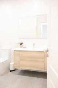 a white bathroom with a sink and a toilet at Piso de lujo en Tenerife La Cochera in Santa Cruz de Tenerife