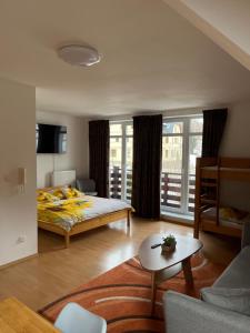 a bedroom with a bed and a living room at Apartmán Labská in Špindlerův Mlýn