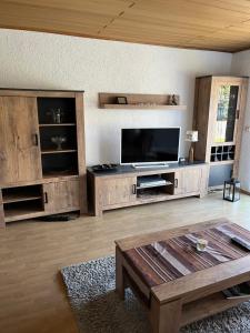 a living room with a large entertainment center with a flat screen tv at Ferienwohnung in Dahn in Dahn