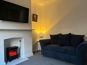 a living room with a couch and a fire place at Nanny and Chips House in Whitby