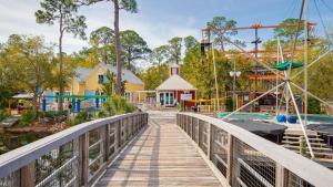 a bridge over a water park with a playground at Luau II 7021 Studio in Destin