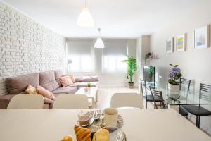 a living room with a couch and a table at CARTAGENAFLATS, Apartamentos Anfiteatro Romano in Cartagena +21 photos