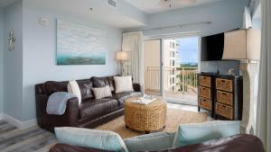 a living room with a couch and a tv at Luau II 7023 in Destin