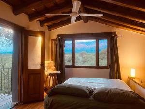 a bedroom with a bed and a large window at Casa en La Comarca in San Javier