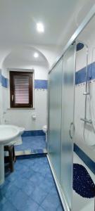 a bathroom with a glass shower and a sink at Casa Pasitea in Taormina