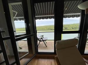 a living room with a chair and a view of the ocean at Mirador Rioja alta golf in Cirueña