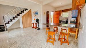 a kitchen with a counter and stools in a room at Lar Lalunalê 3 in Prado
