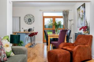 a living room with a table and chairs at Shannonside - Stylish 5 Bed Marina home & 40ft mooring in Termonbarry