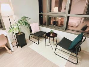 a living room with two chairs and a table at Trip to Songdo in Incheon