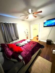 a bedroom with a red bed and a ceiling fan at Fully Equipped Cozy 4/5 BR in Chicago