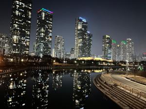 a city skyline with tall buildings and a body of water at Trip to Songdo in Incheon