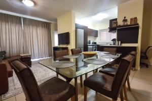 a dining room with a table and chairs and a kitchen at Home Away From Home in Midrand